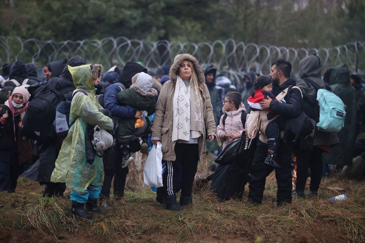Migrants from the Middle East and elsewhere gather at the Belarus-Poland border