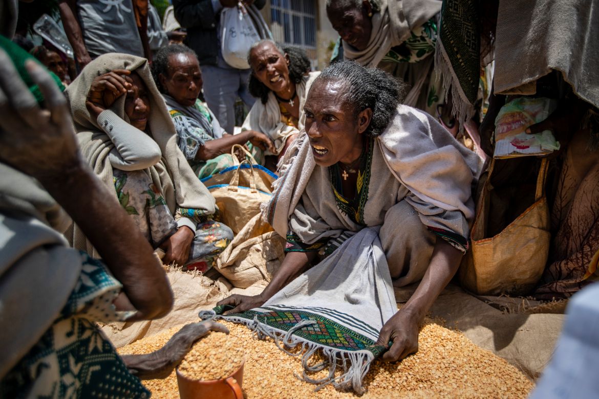 An Ethiopian woman argues with others over the allocation of yellow split peas distributed by the Relief Society of Tigray in the town of Agula, in the Tigray region of northern Ethiopia