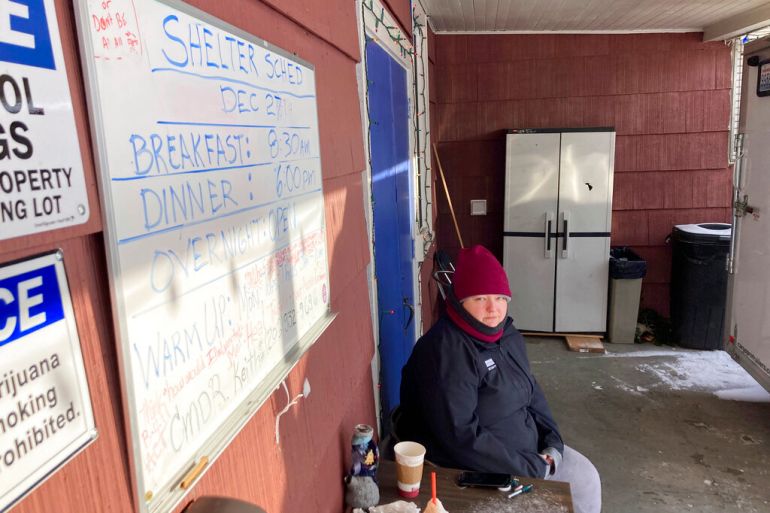 Kaety West sits outside the warming center set up at the West Seattle American Legion Hall Post 160, Monday in Seattle.