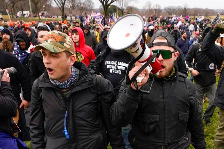 Proud Boys members Zachary Rehl, left, and Ethan Nordean, with handheld megaphone, walk toward the US Capitol in Washington, in support of President Donald Trump on January 6
