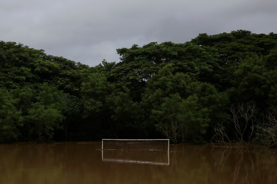 A football goalpost is submerged by floodwaters in Bahia state, Brazil