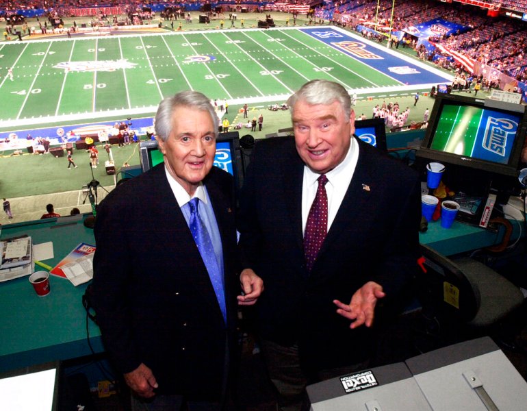 Fox broadcasters Pat Summerall and John Madden stand in the broadcast booth at the Superdome before Super Bowl 36 in 2002, in New Orleans.