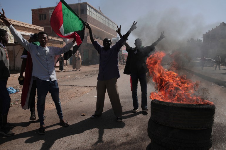 People chant slogans during a protest to denounce the October military coup, in Khartoum, Sudan