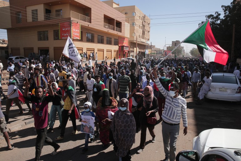 People march during a protest to denounce the October military coup, in Khartoum, Sudan