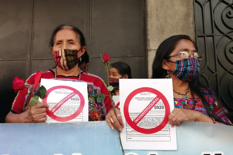 Relatives of victims of conflict-era killings and disappearances protest a 2021 amnesty bill outside Guatemala's Congress