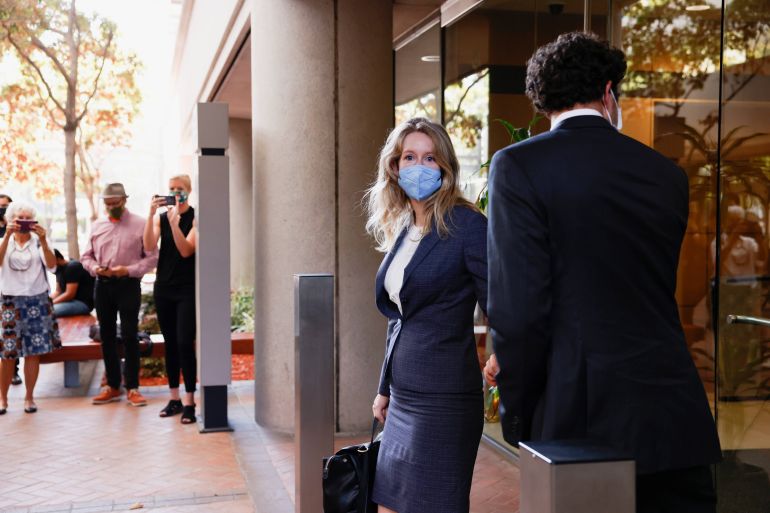 Theranos founder Elizabeth Holmes and her partner Billy Evans leave the Robert F Peckham US Courthouse after the delivery of opening arguments in her trial, in San Jose, California, United States