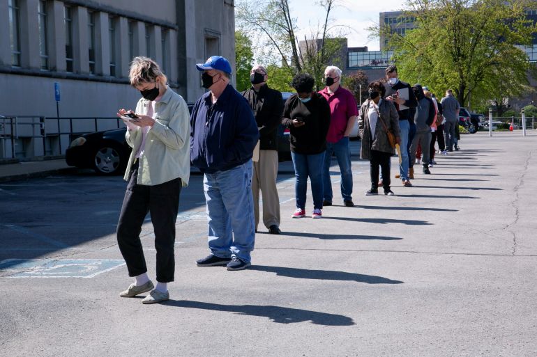 People line up outside a newly reopened career center for in-person appointments in Louisville, U.S.