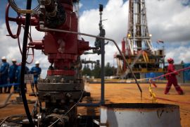 Crude oil drips from a valve at an oil well operated by Venezuela's state oil company PDVSA in Morichal , Venezuela