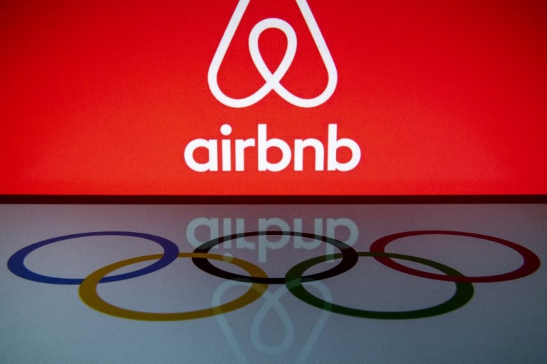 Airbnb logo in the upper half of the frame and Olympic rings logo in the lower half.