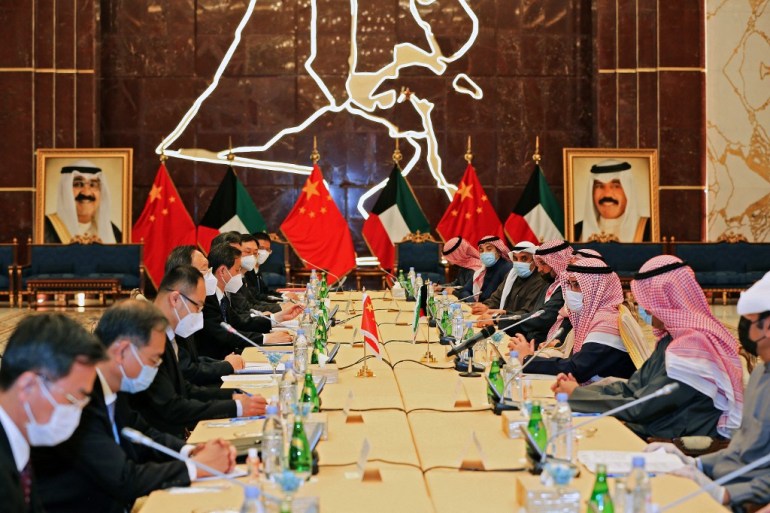 Chinese delegation sits on the left of the table across from Kuwaiti officials in Kuwait