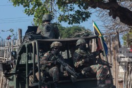 A military convoy of South Africa National Defence Forces (SANDF) rides along a dirt road in the Maringanha district in Pemba, Mozambique