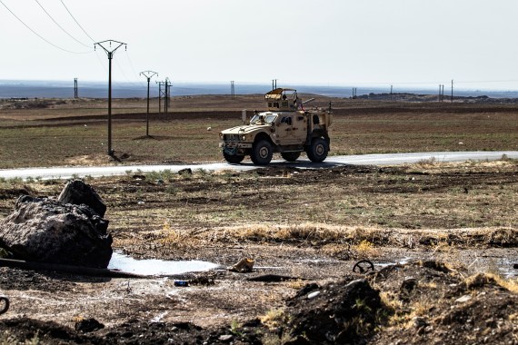 US forces patrol near the Rumaylan (Rmeilan) oil fields in Syria's Kurdish-controlled northeastern Hasakeh province, on November 1, 2021. - The major Rmeilan field, located near a US airbase, has been among the Syrian Kurds' most prized assets since regime forces withdrew early on in the war. (Photo by Delil SOULEIMAN / AFP)