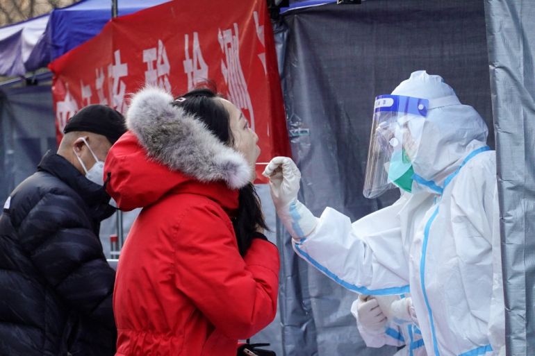 A resident undergoes a nucleic acid test for the COVID-19 coronavirus in Xi'an in China's northern Shaanxi province on December 29, 2021.