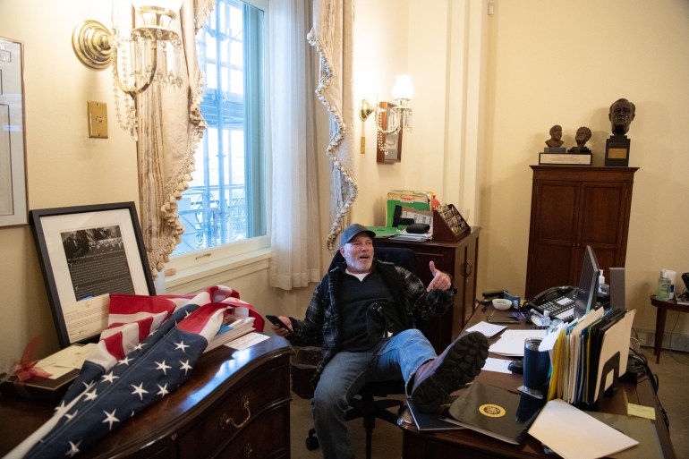 Trump supporter sits with feet up on Nancy Pelosi's desk