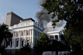 Smoke billows from the roof of a building at the South African Parliament compound in Cape Town.