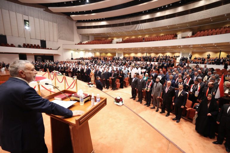 Iraqi lawmakers attend the inaugural parliamentary session in Baghdad