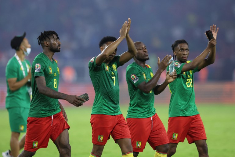 Cameroon players celebrate after beating Burkina Faso in the opening match of the African Cup of Nations