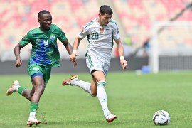 Sierra Leone's forward Mohamed Buya Turay (L) fights for the ball with Algeria's defender Youcef Attal