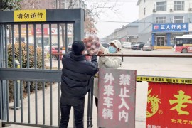A resident receives a food parcel in Anyang in China's central Henan province
