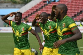 Mali's midfielder Amadou Haidara (L) and Mali's defender Hamari Traore celebrate the goal scored by Mali's forward Ibrahima Kone (R) against Tunisia