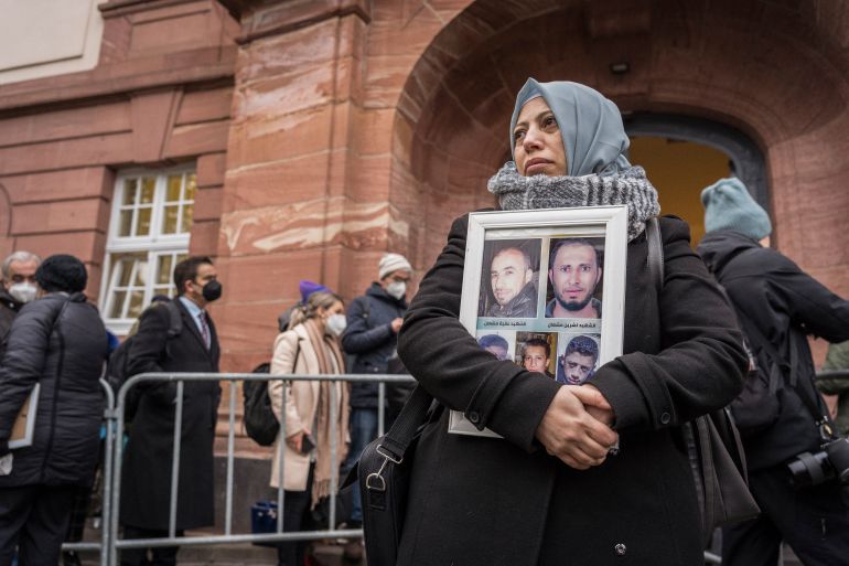 Syrian campaigner of the Caesar Families Association Yasmen Almashan stands outside the state court in Koblenz