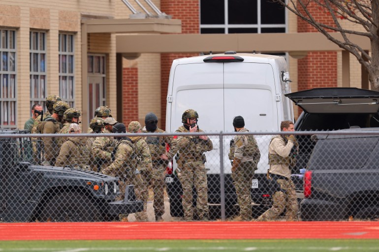SWAT team members deploy near the Congregation Beth Israel Synagogue in Colleyville, Texas.
