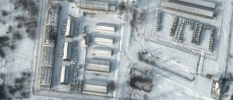 This handout satellite image released by Maxar Technologies shows a close up of armored personnel carriers and trucks at Klimovo storage facility, in Bryansk Oblast, (13 kilometers/8 miles north of the Russia/Ukraine border) storage facility in Russia, January 19, 2022. (Photo by Satellite image ©2022 Maxar Technologies / AFP) / RESTRICTED TO EDITORIAL USE – MANDATORY CREDIT “AFP PHOTO / Satellite image ©2022 Maxar Technologies ” – NO MARKETING – NO ADVERTISING CAMPAIGNS – DISTRIBUTED AS A SERVICE TO CLIENTS – THE WATERMARK MAY NOT BE REMOVED/CROPPED