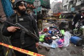 Police officials examine the site of bomb explosion, in Lahore, Pakistan [Arif Ali/AFP]