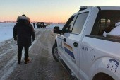 This handout photo released on January 20 shows RCMP officers in Emerson, Manitoba, where four people were found dead [Handout/RCMP/AFP]