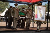 Malian Military guards wheel in the coffin of the late former President of Mali, Ibrahim Boubacar Keita [Florent Vergnes/AFP]