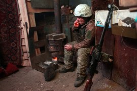 Ukraine soldier sits in bunker