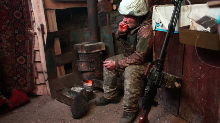 Ukraine soldier sits in bunker