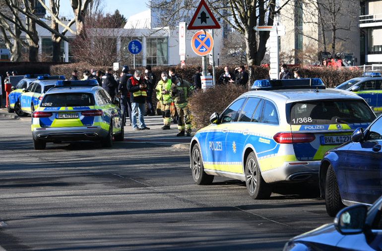 Police cars park on the campus of the University in Heidelberg, southwestern Germany, after an attack