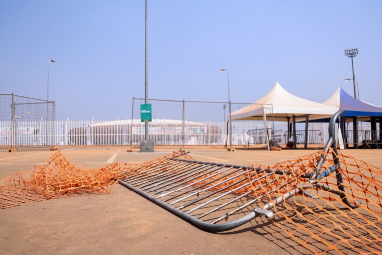 This picture taken on January 25, 2022 at the entrance of Olembe stadium in Yaounde shows barriers on the ground at the scene of the stampede. - Eight people were killed and many more injured in a crush outside a Cameroonian football stadium on January 24, 2022 ahead of an Africa Cup of Nations match.