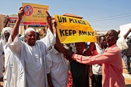 Sudanese pro-military protesters chant slogans as they demonstrate against a UN bid to resolve a political crisis outside the Khartoum office of the UN Transition Assistance Mission Sudan in the Sudanese capital on January 26, 2022.