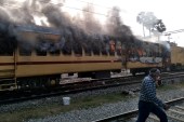 Smoke comes out from a train&#39;s carriage after angry mobs set it on fire in Gaya in the eastern Indian state of Bihar [AFP]