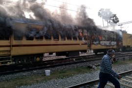 Smoke comes out from a train's carriage after angry mobs set it on fire in protests in Bihar