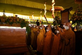 Buddhist monks pray with torches during the cremation for Vietnamese monk Thich Nhat Hanh in Hue province, Vietnam, on January 29, 2022.