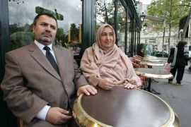 Massouda Jalal, wife of detained Taliban critic Faizullah Jalal is seated at a table