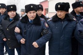 Kazakh riot police stand guard