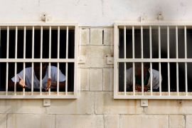 Undocumented migrants look through barred windows at the Safi detention centre outside Valletta, Malta [File: Darrin Zammit Lupi/Reuters]