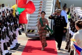 Aung San Suu Kyi walks on a red carpet and reviews honour guards upon arrival at the Manila International airport in the Philippines.