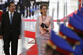 Myanmar's Aung San Suu Kyi and Cambodia's Prime Minister Hun Sen inspect an honour guard at the Peace Palace in Phnom Penh, Cambodia, April 30, 2019.