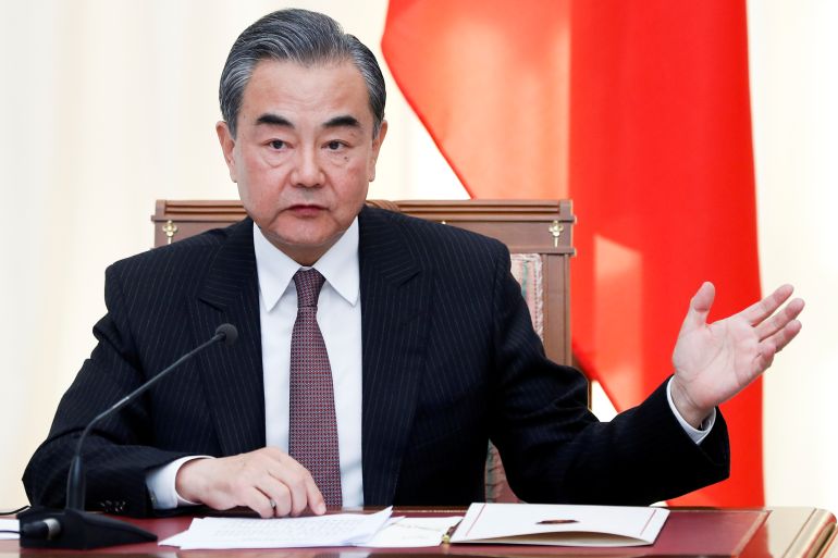 Chinese Foreign Minister Wang Yi gestures while speaking during a news conference.