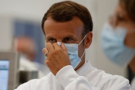French President Macron wearing a mask at a vaccine plant