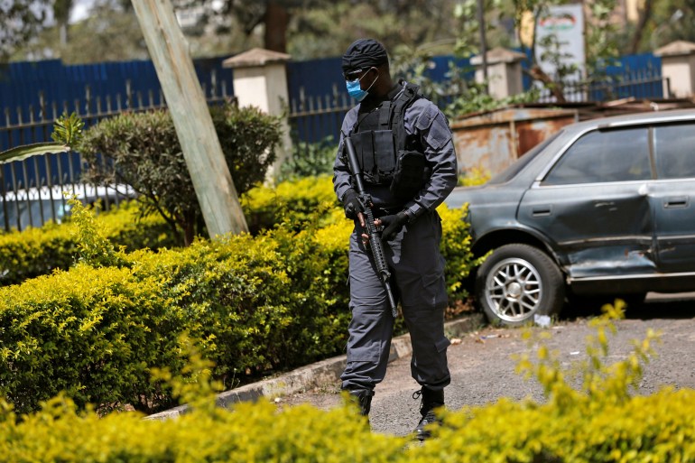 A member of the anti-terror police unit keeps guard at the Milimani Law Courts before the arrival of suspects charged with helping al-Qaeda launch an attack on the Westgate Mall, in Nairobi, Kenya