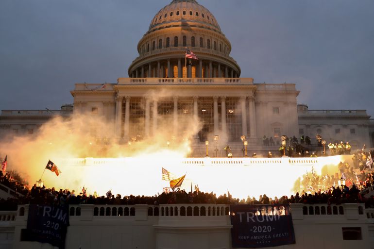 An explosion caused by a police munition is seen while supporters of U.S. President Donald Trump riot in front of the U.S. Capitol Building in Washington,