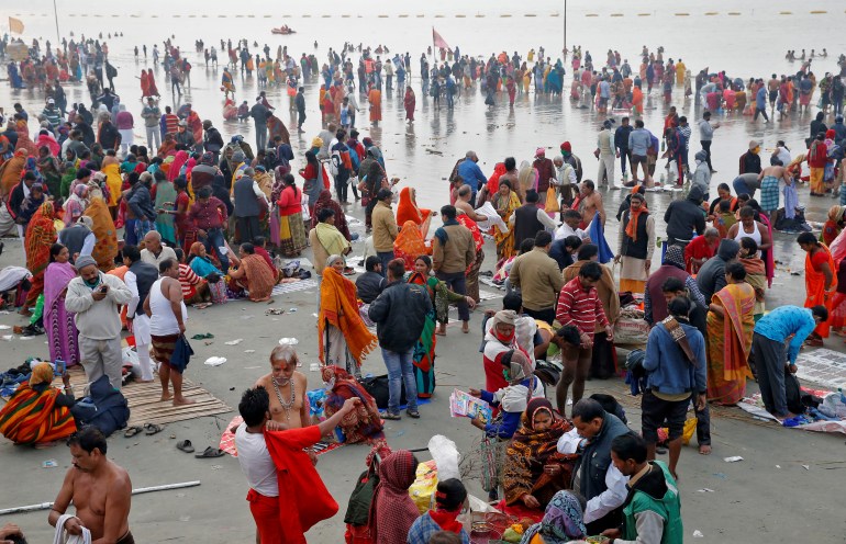 Hindu pilgrims gather on the banks of the Ganges River
