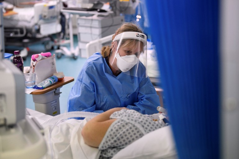 A nurse attends to a patient on a COVID-19 ward at Milton Keynes University Hospital in the United Kingdom