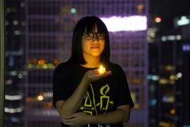 Activist Chow Hang-tung poses with a candle to remember Tiananmen Square in 1989